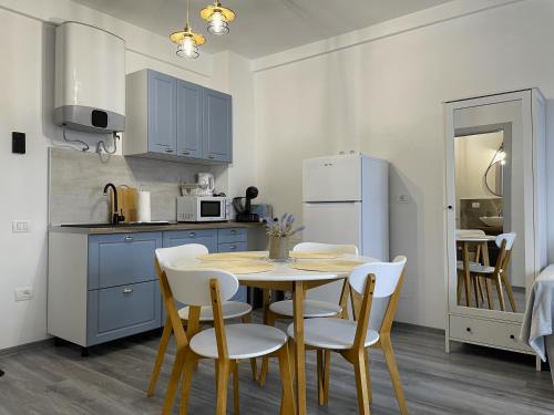 a kitchen with a table and chairs and a refrigerator at Casa Mihuț in Cordău