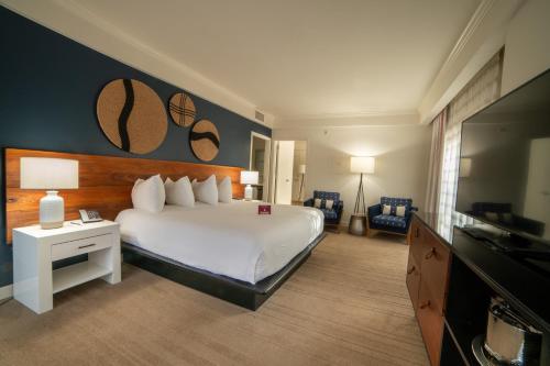 a hotel room with a bed and a flat screen tv at Amara Resort & Spa in Sedona