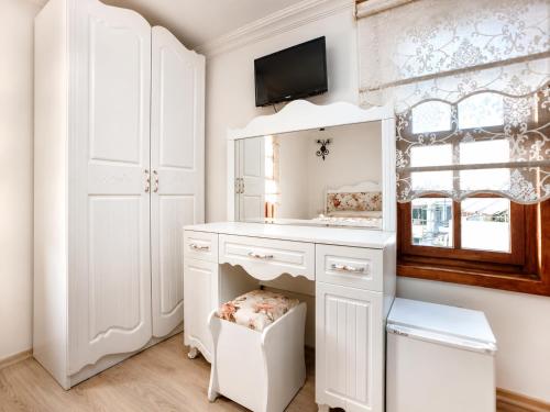 a bathroom with a white vanity and a mirror at Oldtown Patio in Antalya