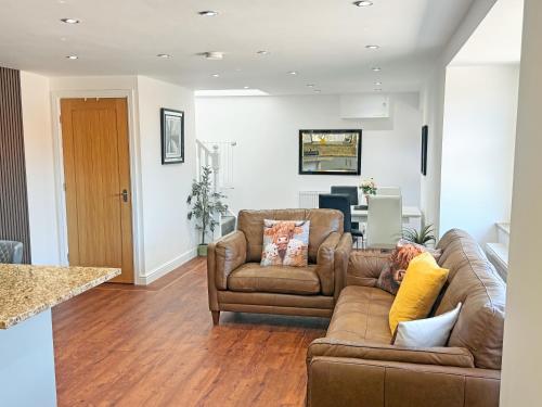a living room with a couch and a table at Roslyn Cottage in Hamsterley