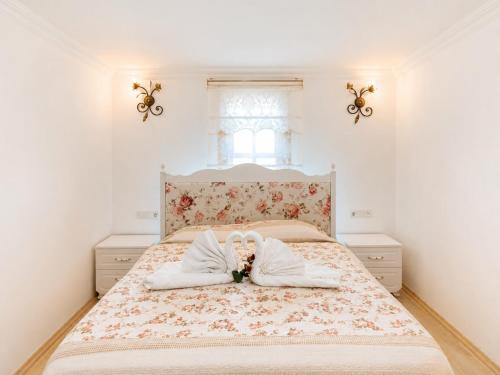 a bedroom with a large bed with a floral bedspread at Oldtown Patio in Antalya