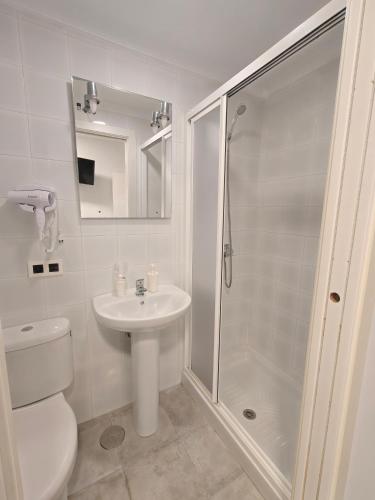 a bathroom with a toilet and a sink and a shower at AYAMONTE ROOMS 43 in Ayamonte