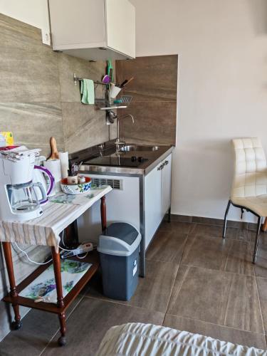 a small kitchen with a sink and a table at Apartment with parking in Dajla