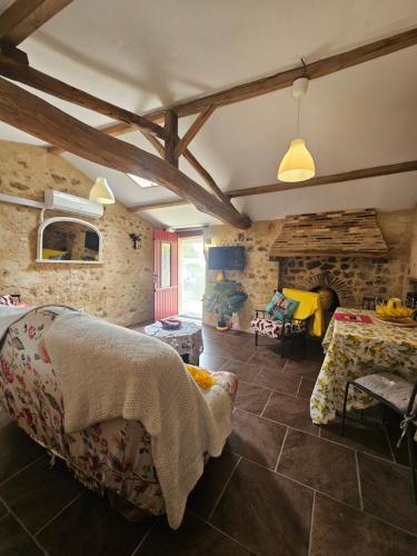 a living room with a table and a fireplace at Gite du Passignac in Saint-Maigrin