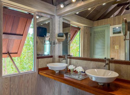 a bathroom with two sinks and a large mirror at Titi Vacation Homes in Cobbs Cross