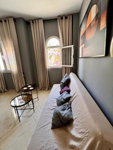 a bedroom with a large bed with pillows on it at la Soukra in Sukrah