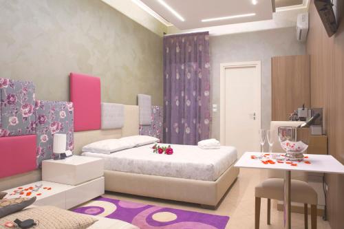 a bedroom with two beds and a table and chairs at Luxury B&B Coccolhouse in San Cesario di Lecce