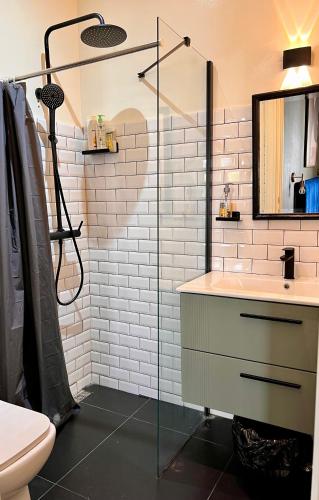 a bathroom with a sink and a glass shower at la Soukra in Sukrah