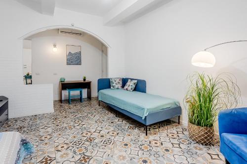 a living room with a blue couch and a table at Le Finestre Sul Borgo 1 in Parma
