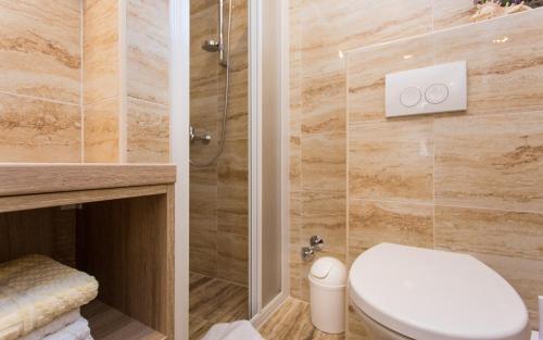 a bathroom with a toilet and a shower at Apartments Polonijo in Baška