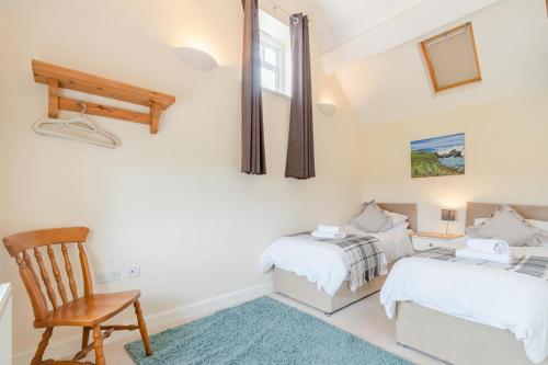 a bedroom with two beds and a chair at 2 Bed in Newark oc-91051 in Caunton