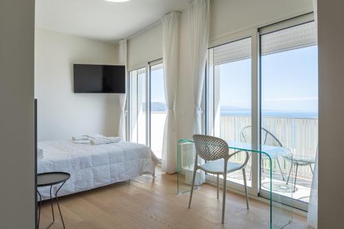 a bedroom with a bed and a table and chairs at Palazzo Ambra in Soverato Marina