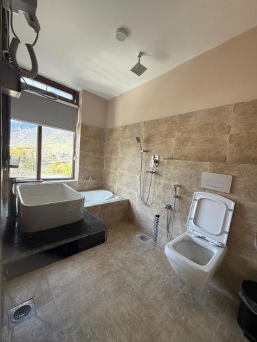 a bathroom with a sink and a toilet and a tub at Bön Valley in Jomsom