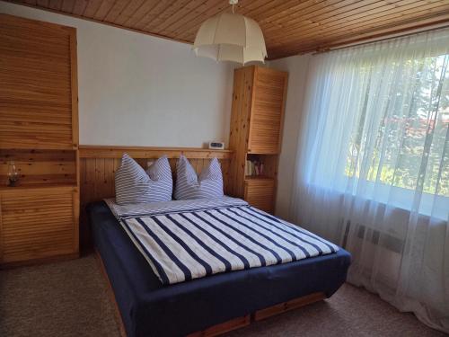 a bedroom with a bed with white pillows and a window at Inselidyll in Karlshagen