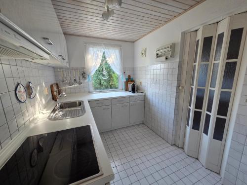 a small kitchen with a sink and a window at Inselidyll in Karlshagen