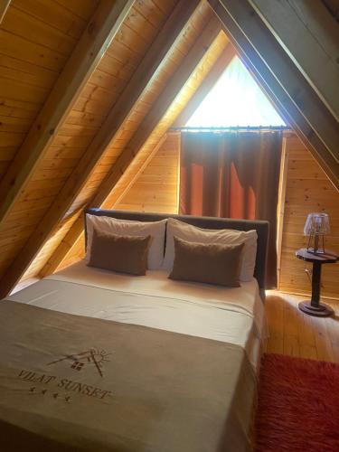 a bedroom with a bed in a attic at Berat Wooden Villas with Private Pool in Berat