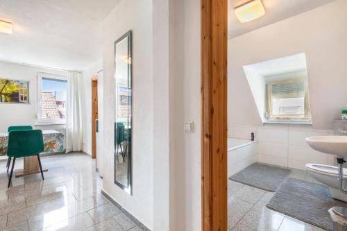 a bathroom with a toilet and a sink and a mirror at Ferienwohnung mit Parkmöglichkeit in Göppingen