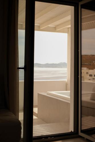 a room with a window with a view of the ocean at NŌSTOS Serifos in Livadi
