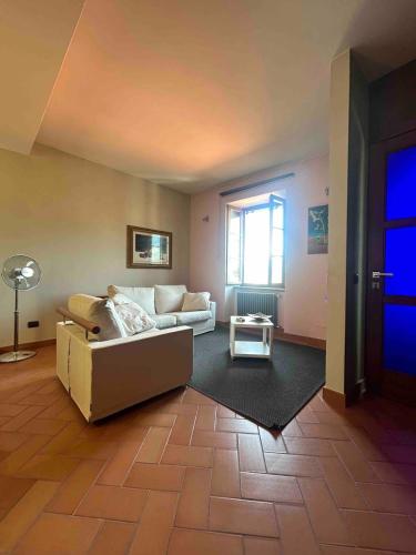 a living room with a couch and a window at La Torretta in Barga