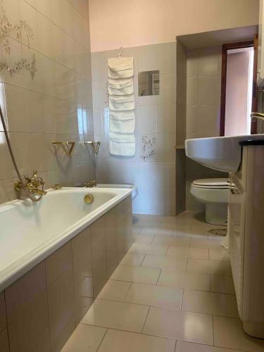 a bathroom with a tub and a toilet and a sink at La Torretta in Barga