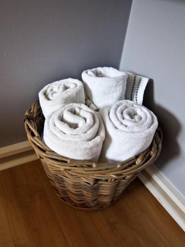 a basket of towels sitting on the floor at Mansfield House in Norwich