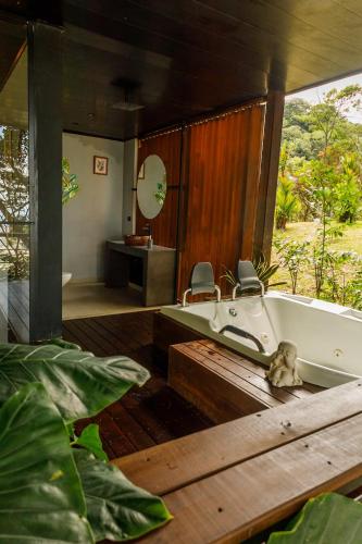 a bathroom with a bath tub and a sink at Itawa ecoparque in Villavicencio