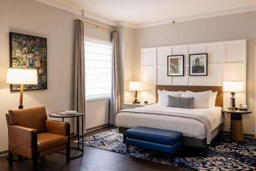 a hotel room with a bed and a chair at Heathman Hotel in Portland