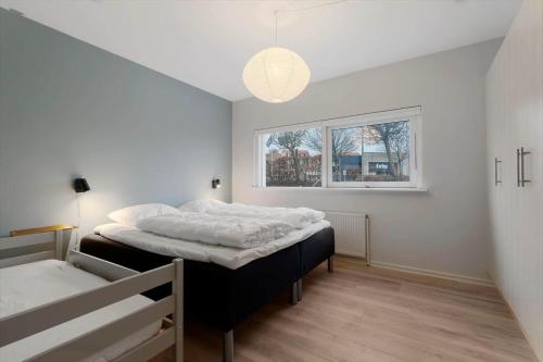 a bedroom with two beds and a window at 84286-Ebeltoft-Ndr-Strandvej-3-M in Ebeltoft