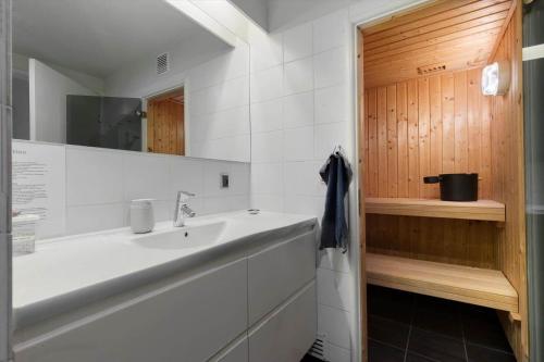 a bathroom with a sink and a mirror at 84286-Ebeltoft-Ndr-Strandvej-3-M in Ebeltoft