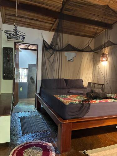 a bedroom with a bed with a mosquito net at Casa Acquamarina in Atins