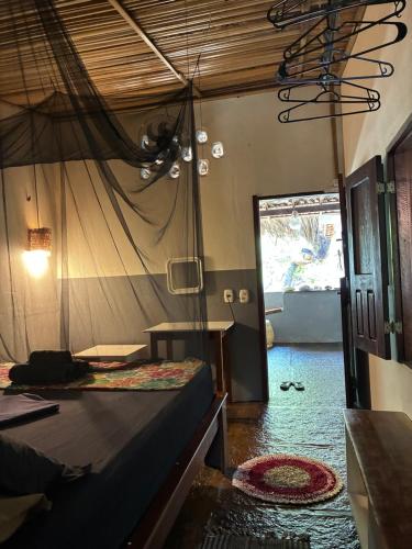 a room with a bed and a room with a door at Casa Acquamarina in Atins