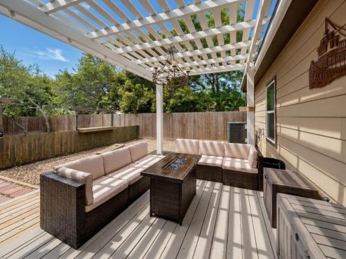 a patio with a couch and a table on a deck at Ferrymans Landing in Aransas Pass