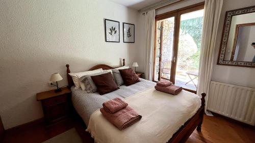 a bedroom with a bed with two towels on it at New listing! House with pool and garden, Urús in Urus