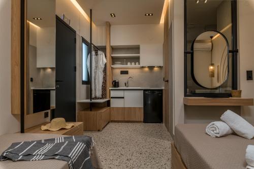 a bedroom with two beds and a sink and a mirror at Six Doors in Pefkochori