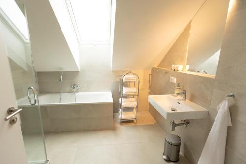 a bathroom with a sink and a bath tub at Lipno Verde in Lipno nad Vltavou