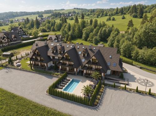 an aerial view of a large house with a swimming pool at Aparthotel Diamond SPA Relax in Białka Tatrzańska
