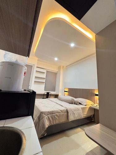 a bedroom with a bed and a large mirror at The alt room by Vivo apartemen in Yogyakarta