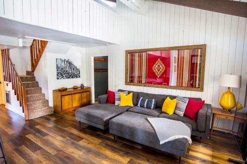 a living room with a gray couch with colorful pillows at Mammoth's Best Location! 2BRLoft by Canyon Lodge in Mammoth Lakes