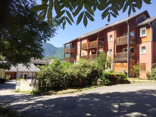 an apartment building with a road in front of it at location Ax les Thermes in Ax-les-Thermes