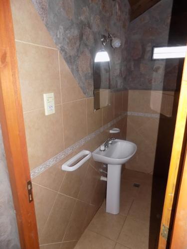 a bathroom with a sink and a toilet at Cabañas Wasirumi Pileta y bajada al Rio in Bialet Massé
