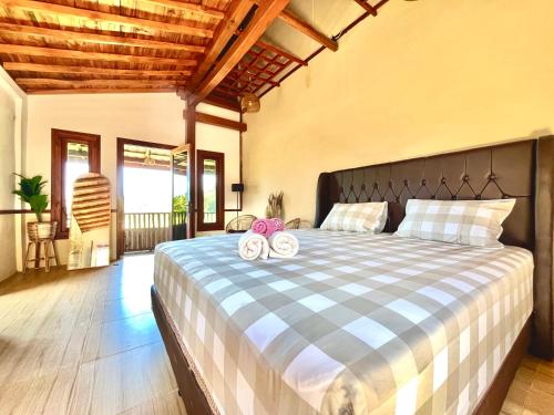 a bedroom with a bed with two towels on it at Omah Osing Ijen Banyuwangi in Licin