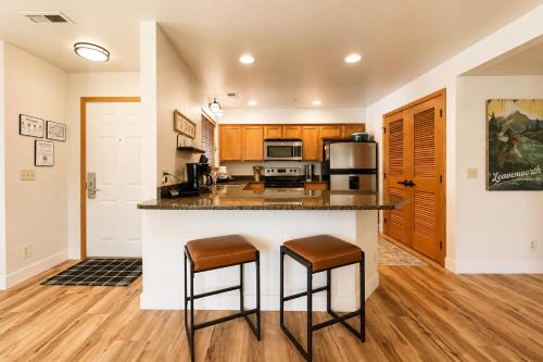 a kitchen with a counter and two stools at Edelweiss Escape in Leavenworth