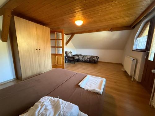 a bedroom with a large bed in a room at Pension V Doubí apartmán se sdílenou koupelnou in Slavče