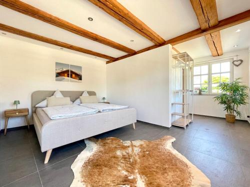 a bedroom with a bed in a room with wooden ceilings at Appartement "Loft Seeliebe" in Kreuzlingen