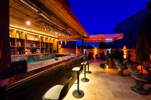 a bar with a row of seats at night at Rustic Caves in Göreme