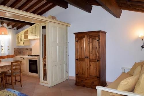 a kitchen and living room with a door and a table at Il Cantinone A due passi dal mare in San Vincenzo