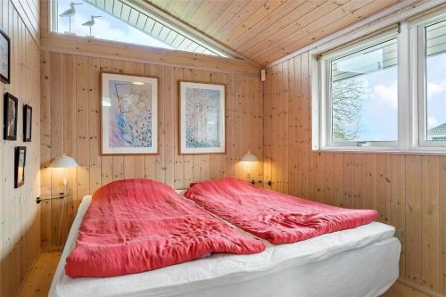 a large red bed in a room with wooden walls at 30101-Malling-Noddevaenget-5-A in Malling