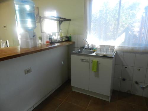 a small kitchen with a sink and a window at CASA DESERT in San Pedro de Atacama