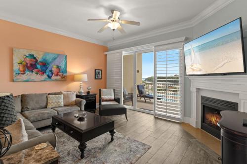a living room with a couch and a fireplace at Sanctuary at Redfish 2115 by Newman-Dailey in Santa Rosa Beach