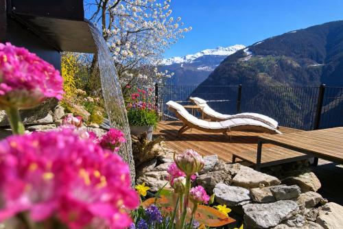 a garden with a bench and a water fountain at Mattertal Lodge in Embd
